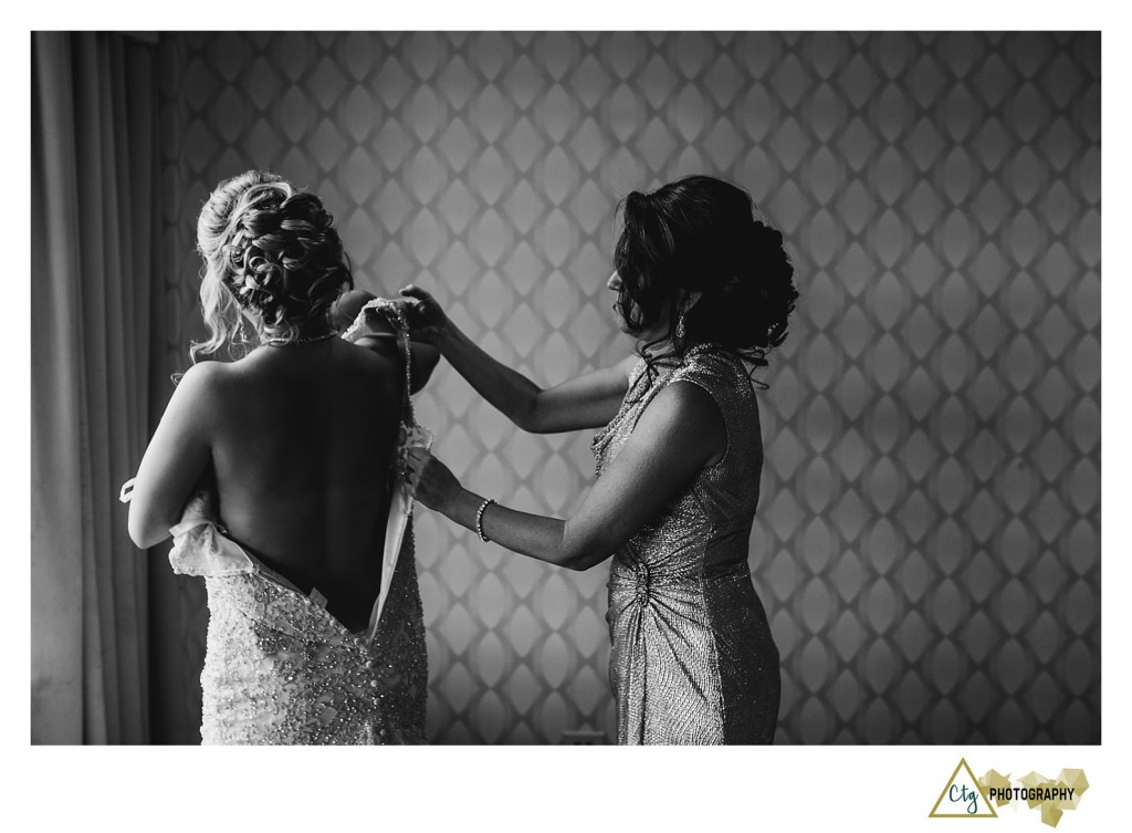 bride putting on dress