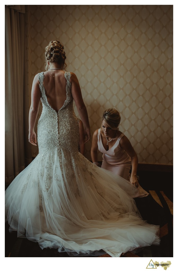 bride putting on dress