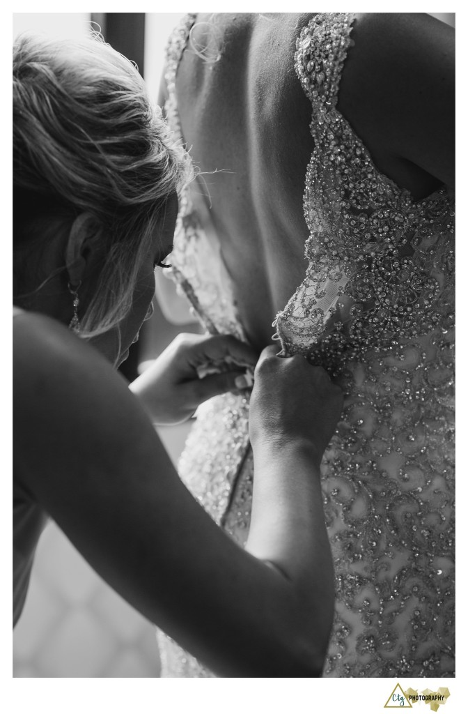 bride putting on dress