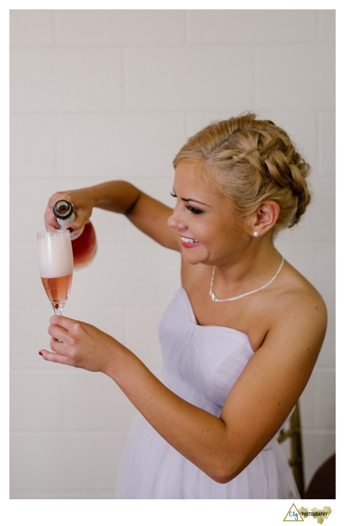 bridesmaid pouring champagne