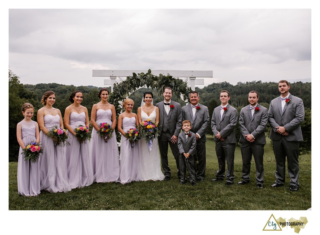 bridal party under arch