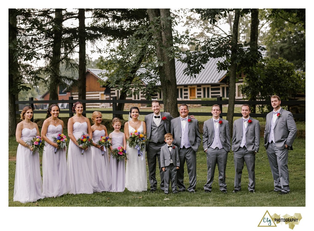 bridal party near a fence