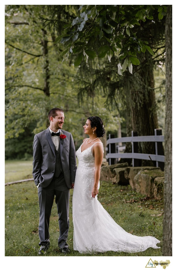 bride and groom near a fence