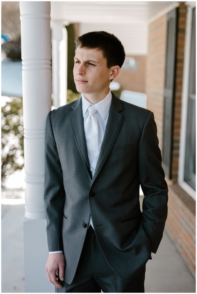 groom standing on porch