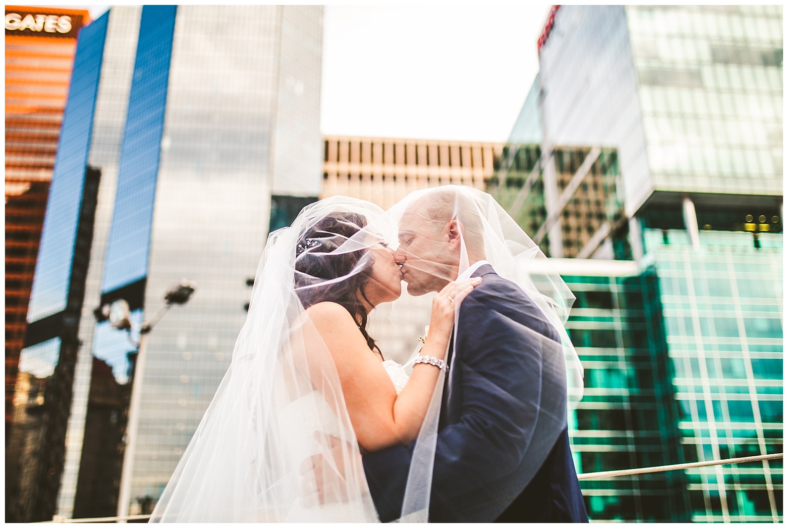 bride and groom under veil