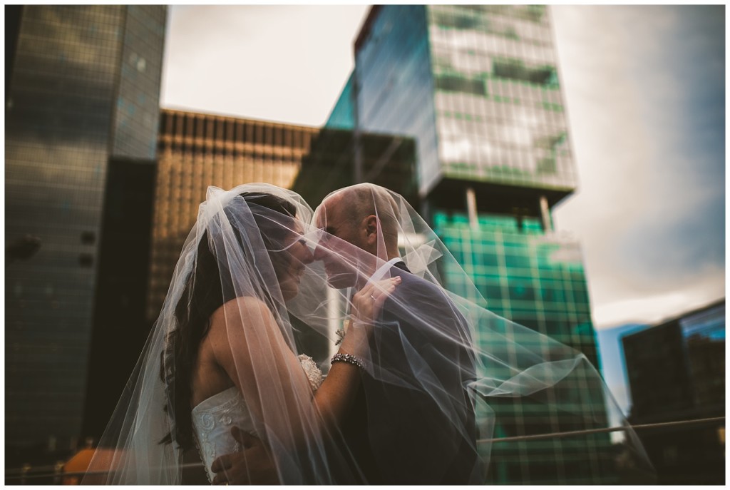 bride and groom under veil