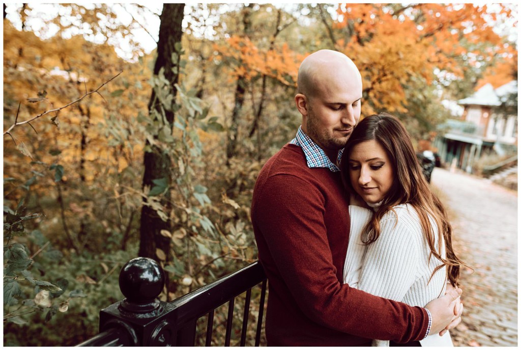 Couple cuddling near fall leaves