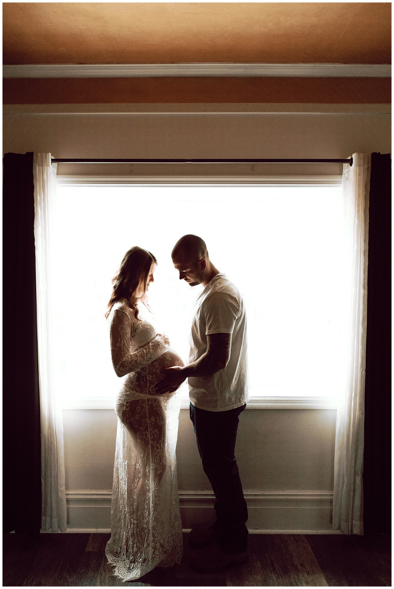 in home maternity session with lace dress by window
