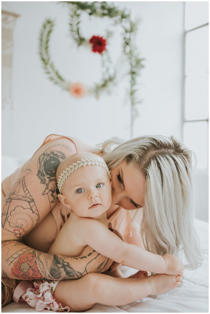 mom kissing daughter