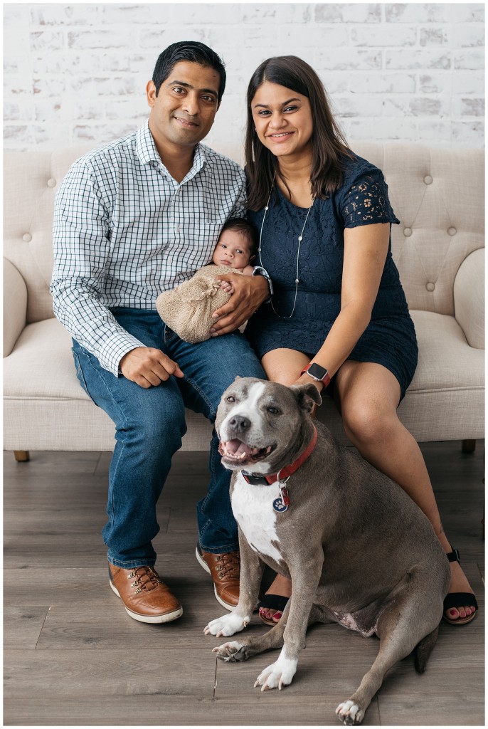 family posing with newborn