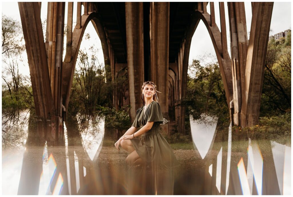senior photo of a girl under a bridge
