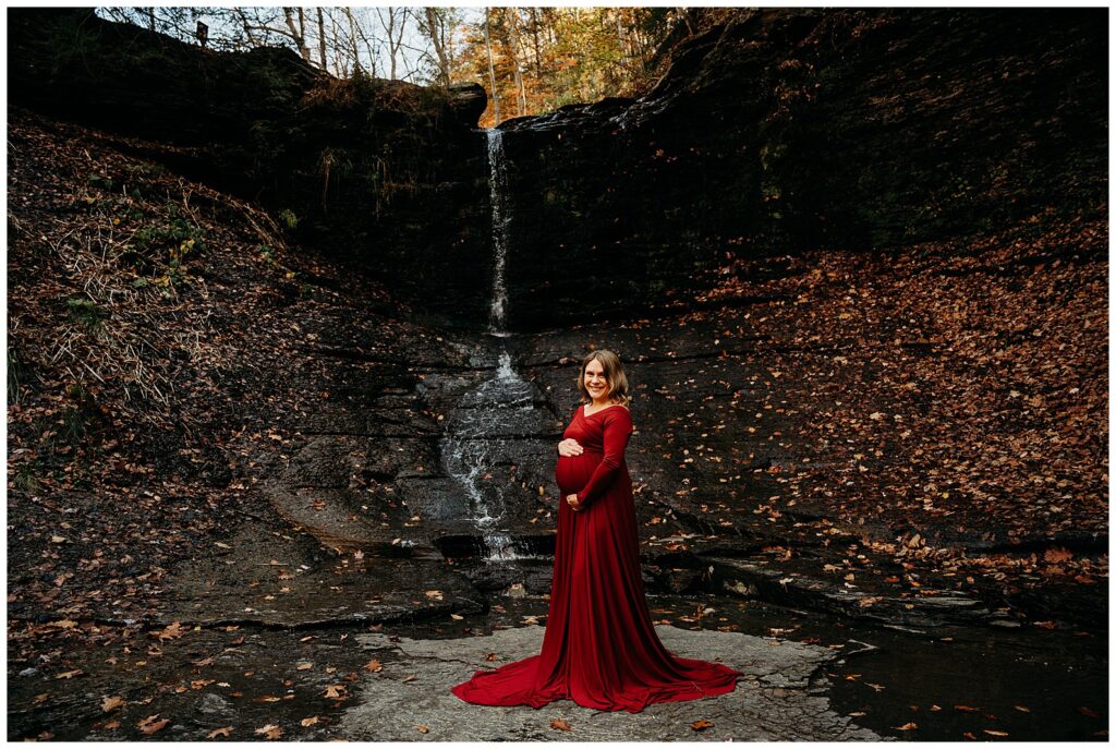 Fall run park maternity photos by waterfall