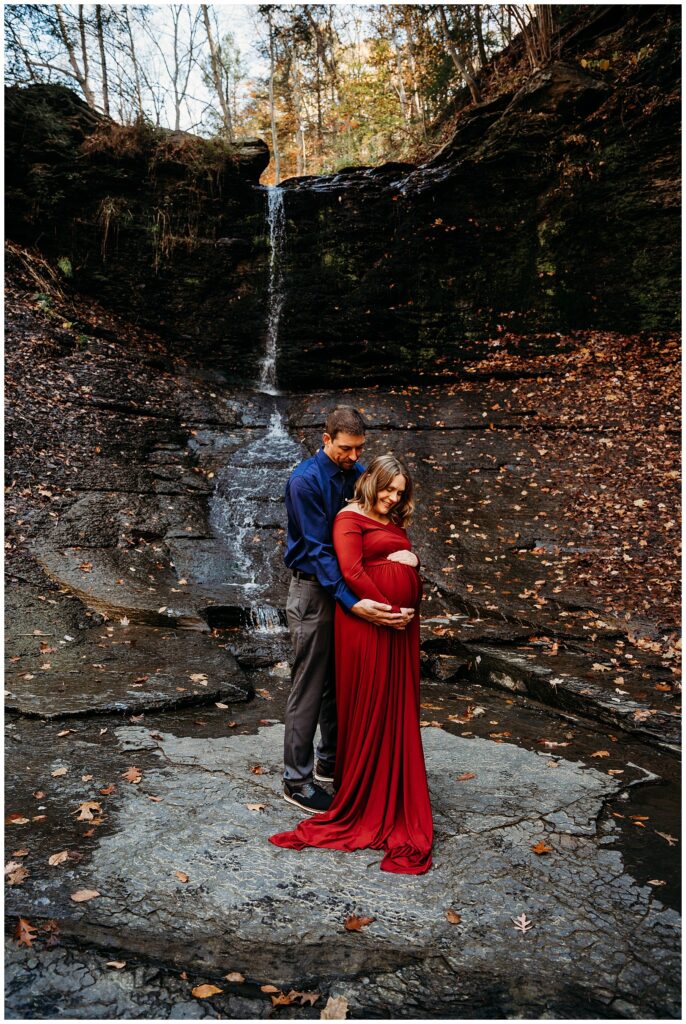 Fall run park maternity photos by waterfall