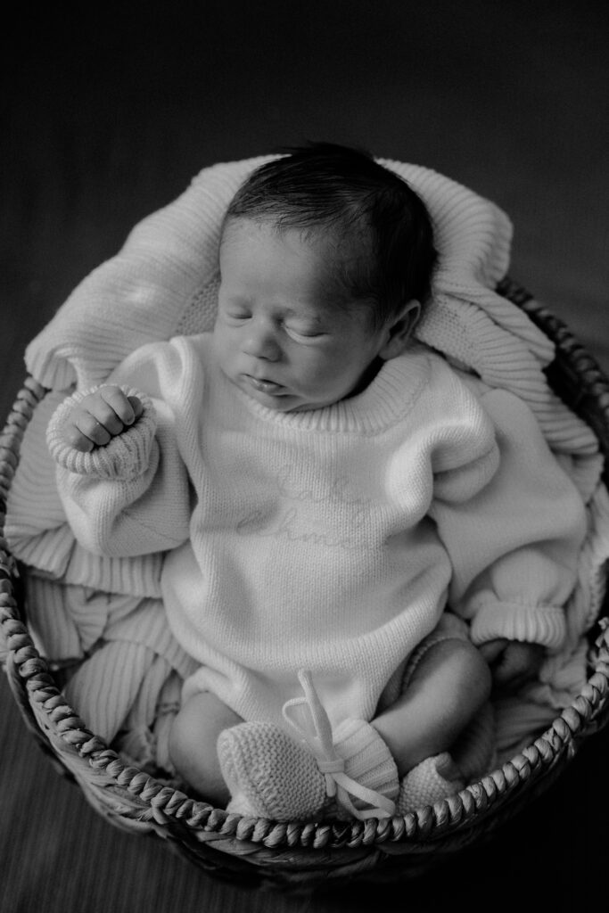 black and white newborn photo in a basket